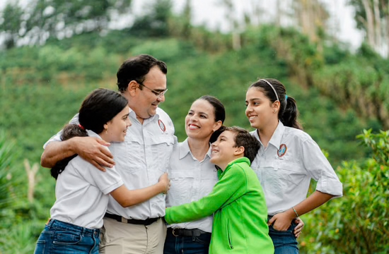 Claudia Vanessa Rivera with her family among the coffee plants at La Virgen Estate.